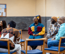 A group of people sat in a community building discuss plans.