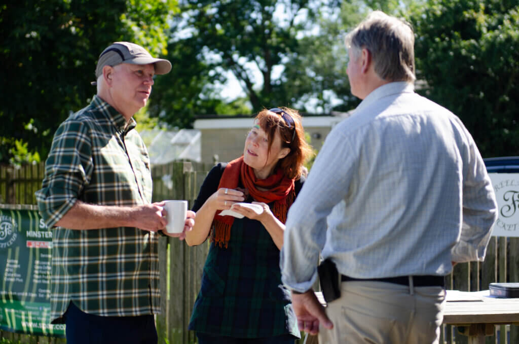 Community members talking with a Low Carbon Hub stall in the background.