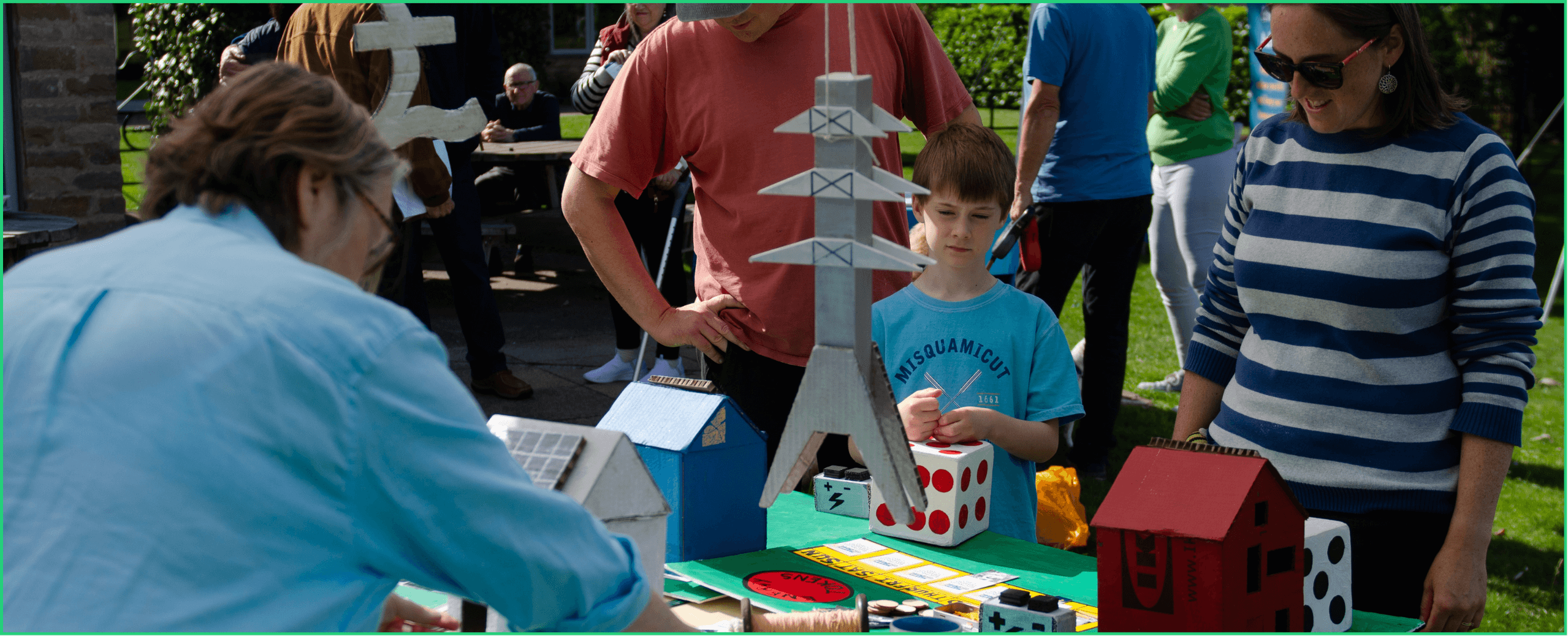 A family learn more about energy systems at a CAPZero event.