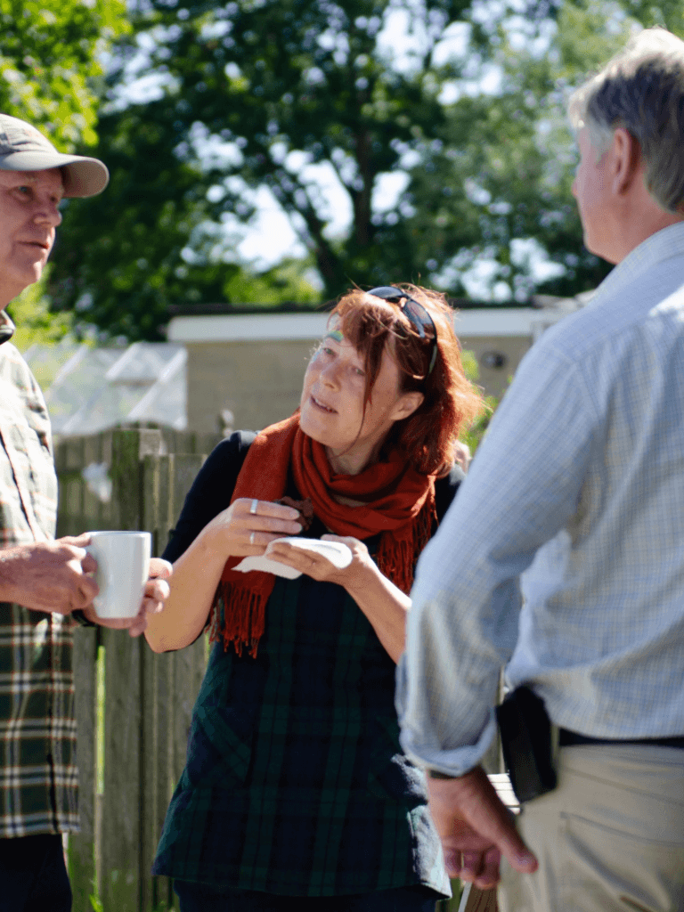 Community members talking with a Low Carbon Hub stall in the background.